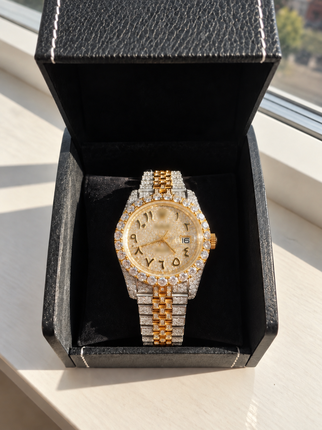 Two-tone watch presented in a black box; branding obscured